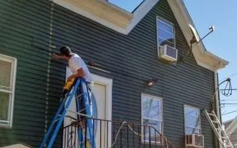 Waze Construction Worker Prepping Siding for Addition